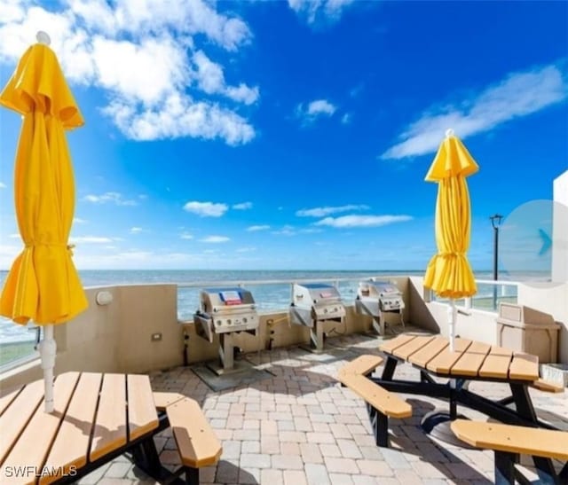 450 S Gulfview Blvd Unit 505, Clearwater, FL 33767 - view of patio / terrace featuring a water view and area for grilling