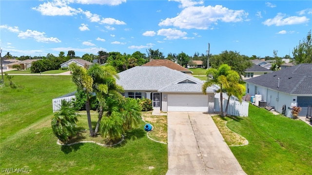 view of front of property with a garage and a front lawn