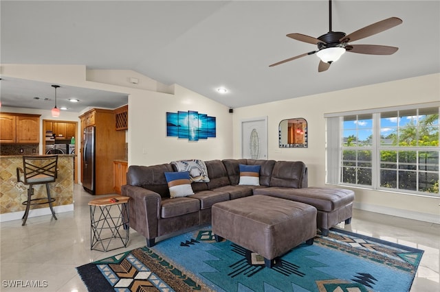 living room featuring lofted ceiling, ceiling fan, and light tile patterned flooring