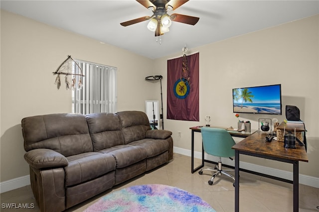 tiled home office featuring ceiling fan