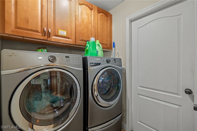 laundry room with cabinets and washing machine and dryer