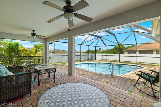 view of pool featuring a patio area, ceiling fan, and a lanai