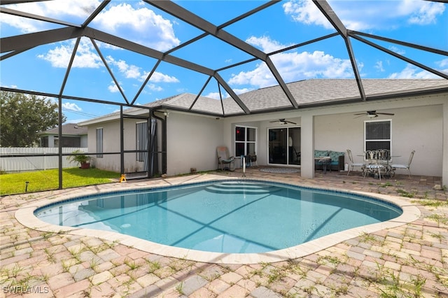 view of pool with ceiling fan, a patio, and glass enclosure