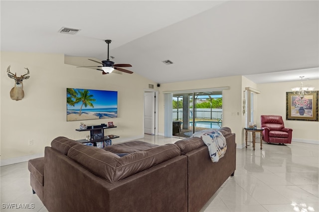 living room featuring ceiling fan with notable chandelier and lofted ceiling