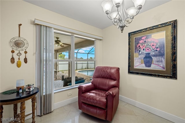 living area featuring ceiling fan with notable chandelier and light tile patterned floors