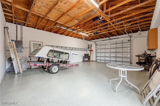 4930 Edith Esplanade, Cape Coral, FL 33904 - garage featuring electric panel and a garage door opener
