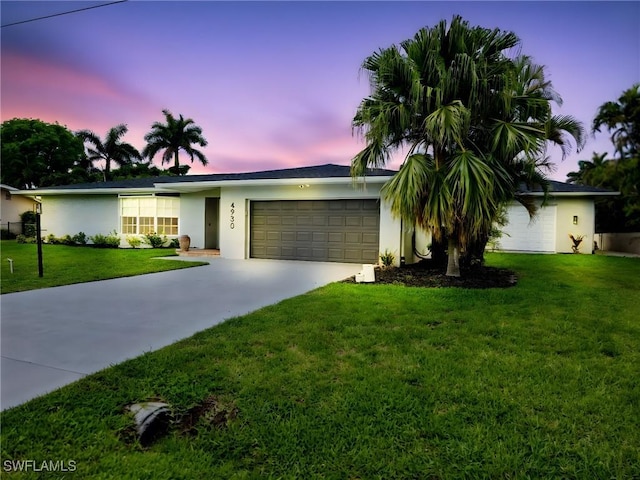 4930 Edith Esplanade, Cape Coral, FL 33904 - ranch-style house featuring driveway, a garage, stucco siding, and a front yard