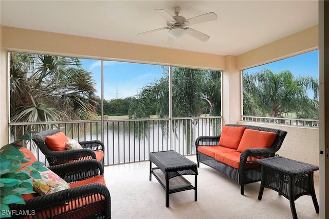 sunroom / solarium with a water view, ceiling fan, and a healthy amount of sunlight