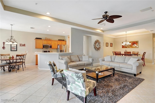 living room featuring ceiling fan with notable chandelier and light tile patterned flooring