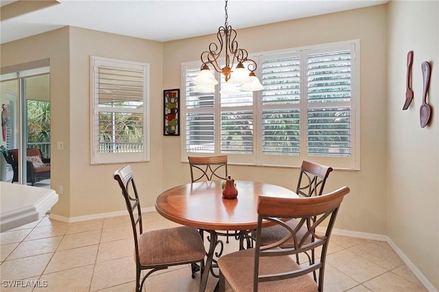 dining room featuring an inviting chandelier, baseboards, and light tile patterned floors