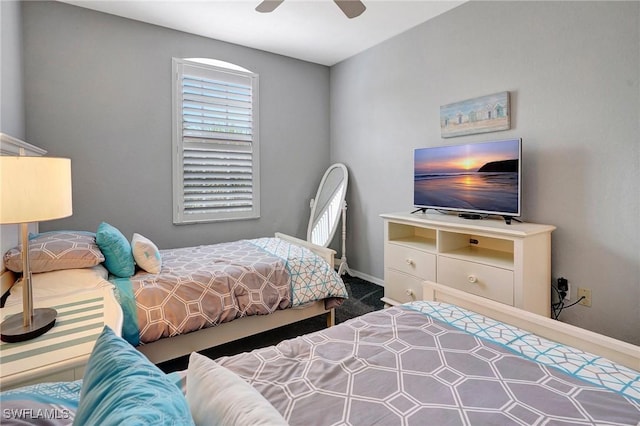 carpeted bedroom with baseboards and a ceiling fan