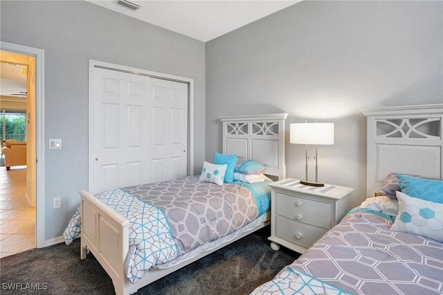 carpeted bedroom with a closet