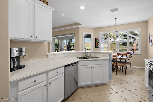 kitchen with visible vents, appliances with stainless steel finishes, white cabinets, a sink, and a peninsula