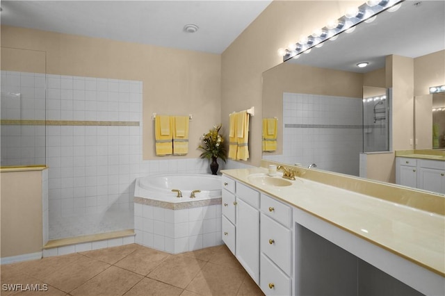 bathroom with a walk in shower, vanity, a bath, and tile patterned floors