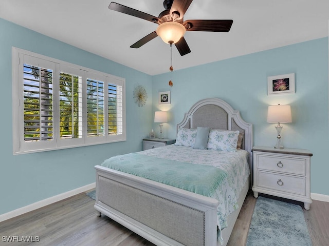 bedroom featuring light hardwood / wood-style floors and ceiling fan