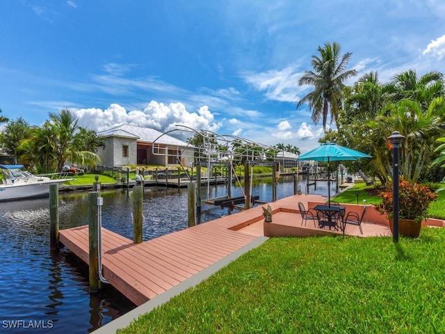 dock area featuring a water view and a yard