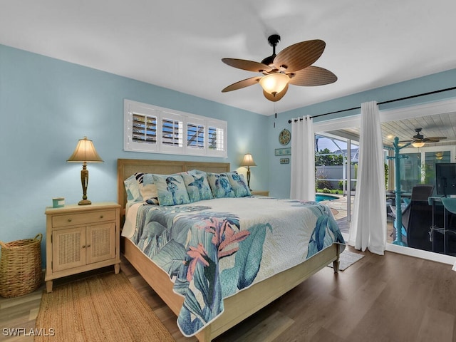 bedroom featuring dark hardwood / wood-style floors, access to exterior, and ceiling fan