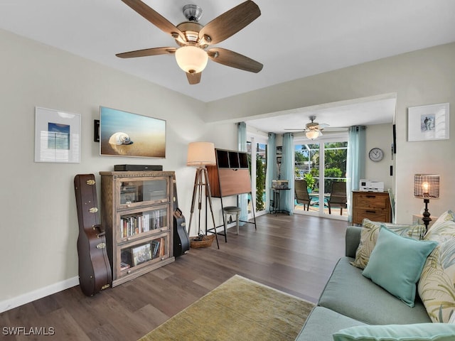 living room featuring ceiling fan and dark hardwood / wood-style flooring