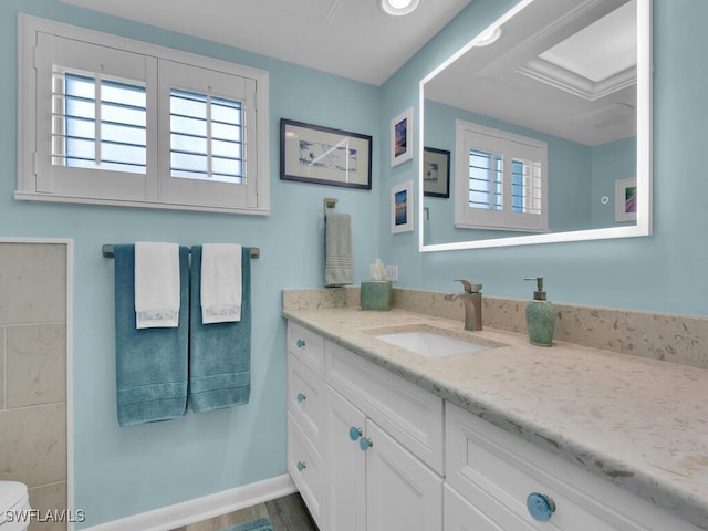 bathroom with vanity, toilet, and wood-type flooring