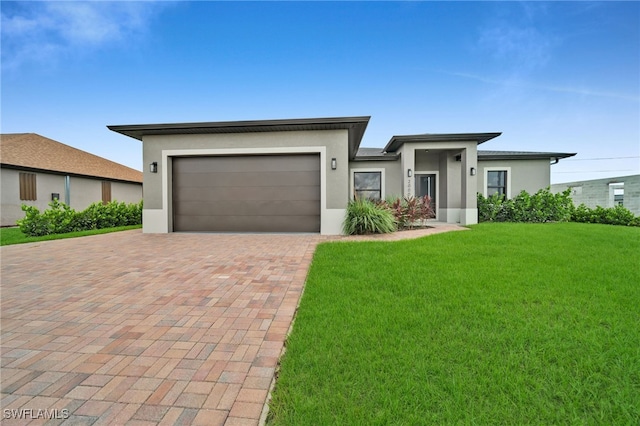 prairie-style home featuring a front lawn and a garage