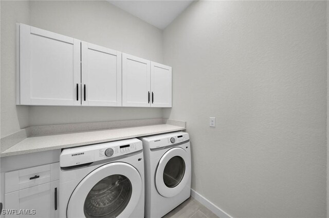 laundry room with cabinets and separate washer and dryer