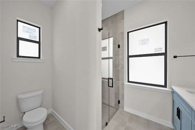 bathroom with plenty of natural light, vanity, toilet, and an enclosed shower