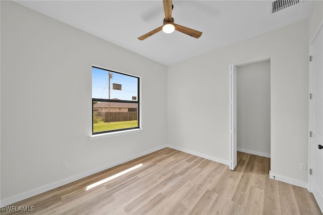 unfurnished bedroom with light wood-type flooring, a closet, and ceiling fan