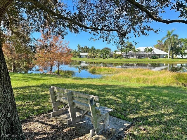 view of property's community featuring a water view and a lawn