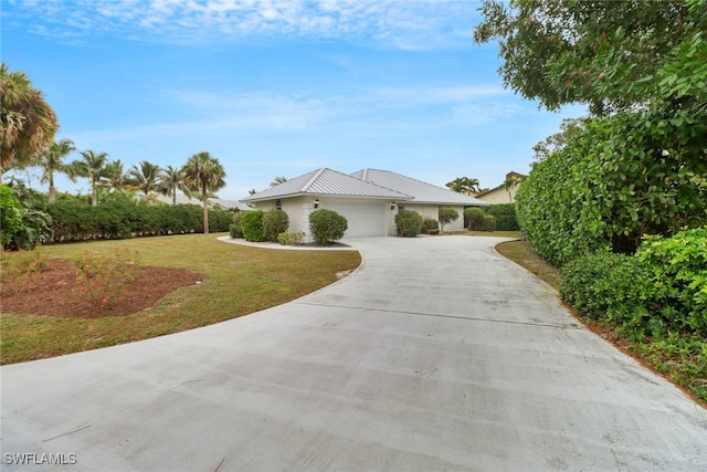 view of front of house with a garage and a front yard