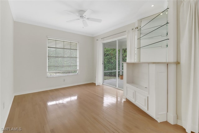 unfurnished room with crown molding, ceiling fan, and light hardwood / wood-style flooring