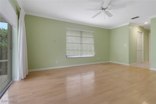 empty room with ornamental molding, ceiling fan, and light wood-type flooring