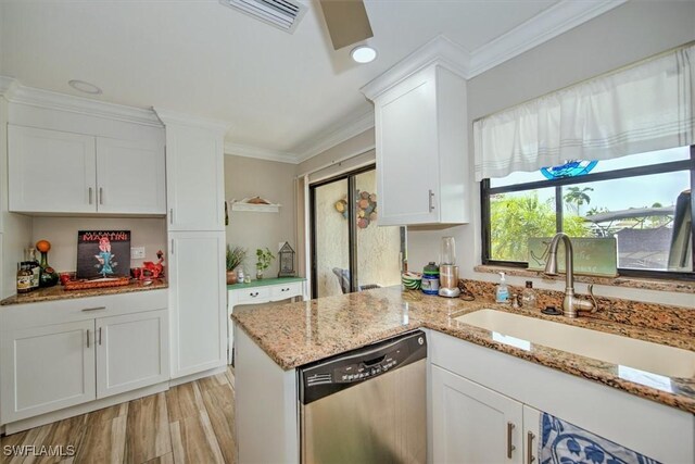 kitchen with stainless steel dishwasher, sink, light hardwood / wood-style flooring, and white cabinetry