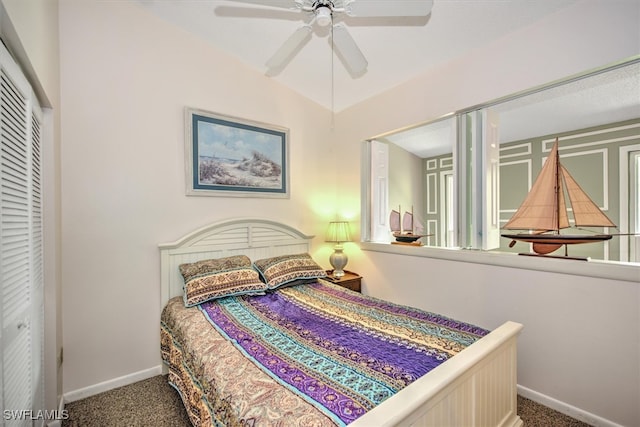 bedroom featuring lofted ceiling, a closet, ceiling fan, and carpet floors