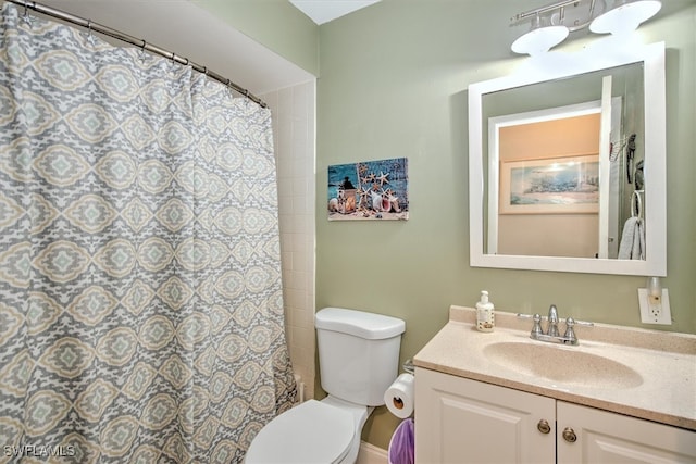 bathroom featuring vanity, toilet, and a shower with shower curtain