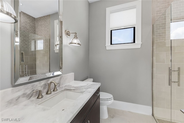 bathroom featuring baseboards, toilet, marble finish floor, vanity, and a shower stall