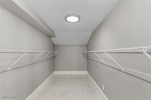 walk in closet featuring lofted ceiling