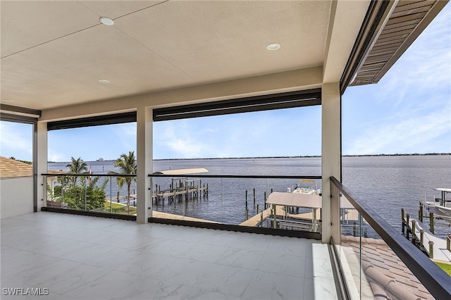 view of dock featuring a water view and a balcony