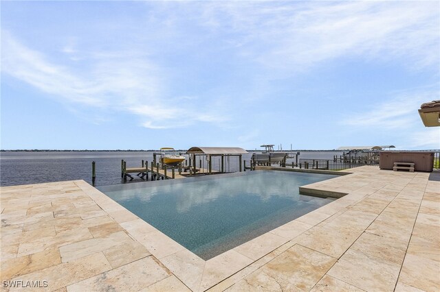 view of swimming pool featuring a dock, a hot tub, and a water view