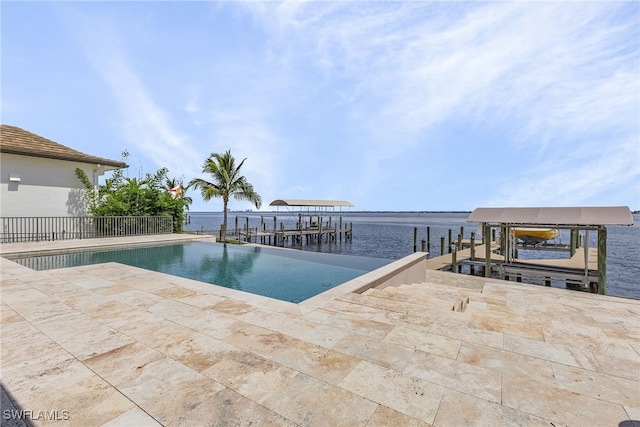 view of pool featuring a boat dock, a water view, and a patio