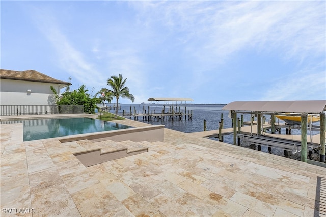 view of swimming pool with a water view, a patio, and a boat dock