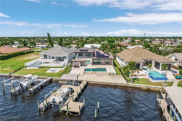 view of dock with a patio, a water view, boat lift, and an outdoor pool