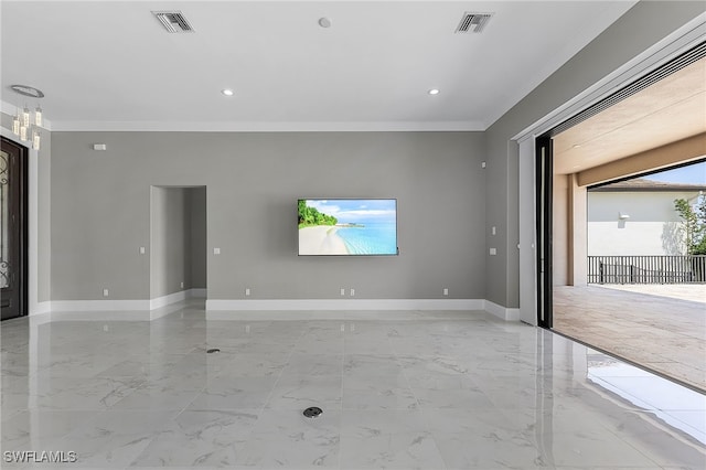 unfurnished living room with crown molding and an inviting chandelier