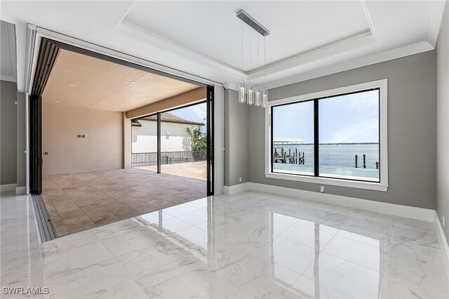 spare room with a water view, crown molding, and a notable chandelier