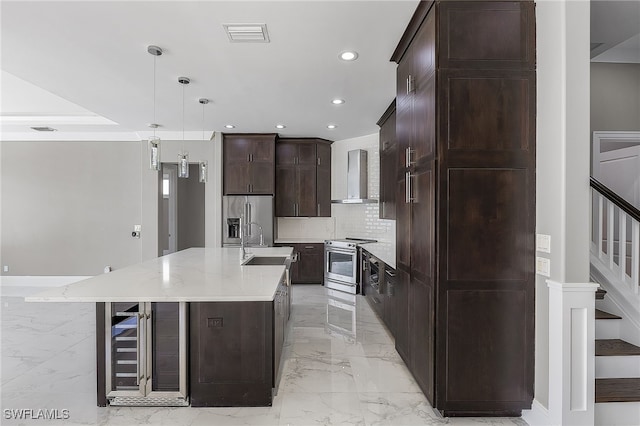 kitchen with stainless steel appliances, visible vents, marble finish floor, wall chimney range hood, and dark brown cabinets