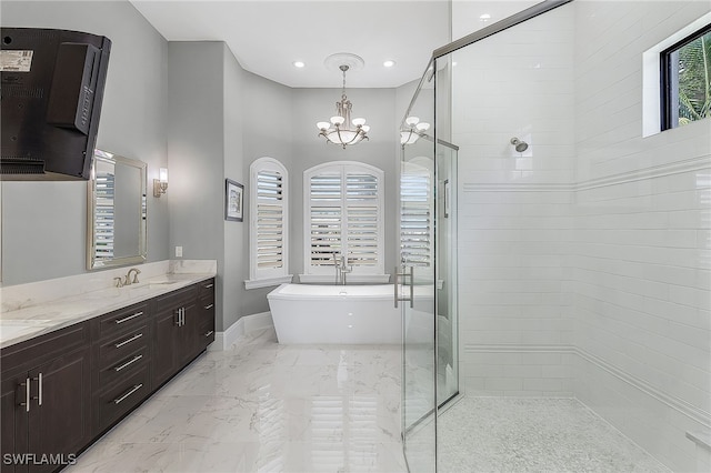 bathroom featuring marble finish floor, double vanity, a freestanding bath, a sink, and tiled shower