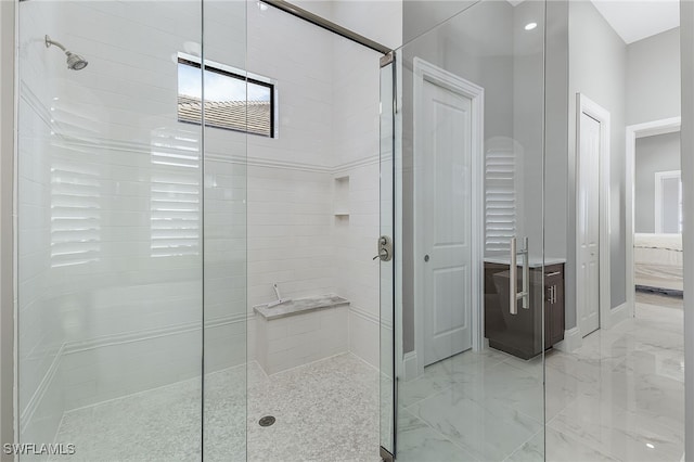 ensuite bathroom featuring marble finish floor, a shower stall, and connected bathroom