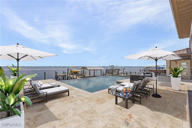 view of swimming pool featuring a dock, a patio area, a water view, and boat lift