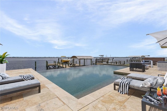 pool with a patio, boat lift, a water view, a boat dock, and an outdoor living space