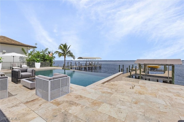 view of dock featuring boat lift, a water view, an outdoor living space, an outdoor pool, and a patio area