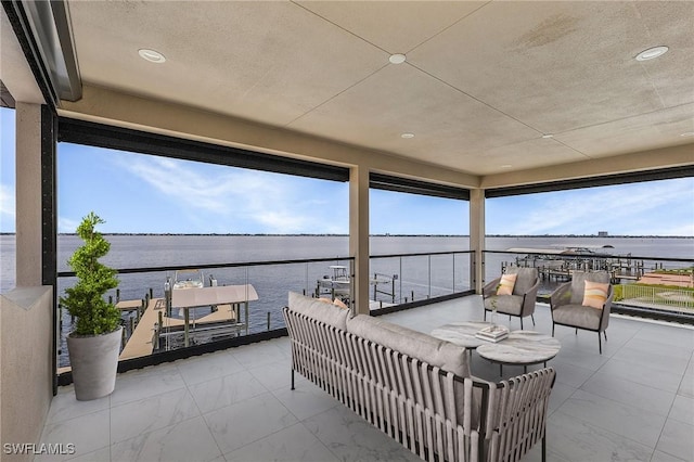 view of patio with a water view and a balcony